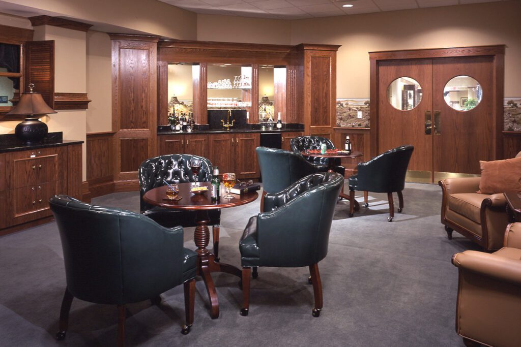 The English Room at Avalon Square is a well-appointed gathering space with leather seating and warm wood work.